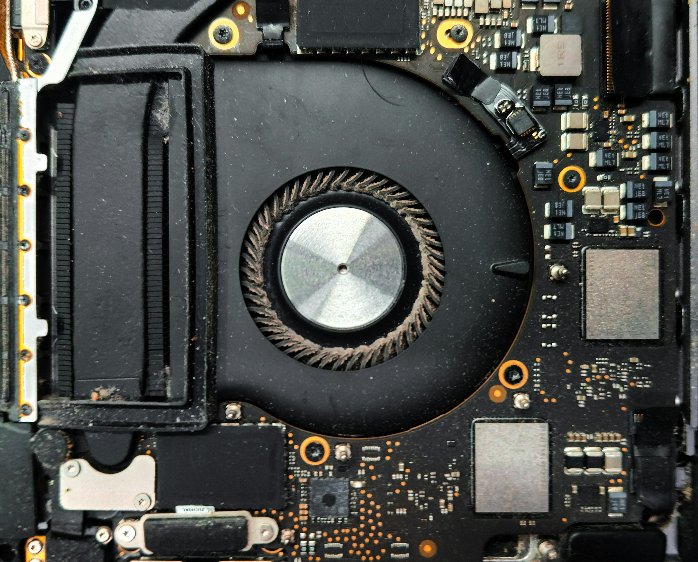 Close-up of a laptop cooling fan and circuit board